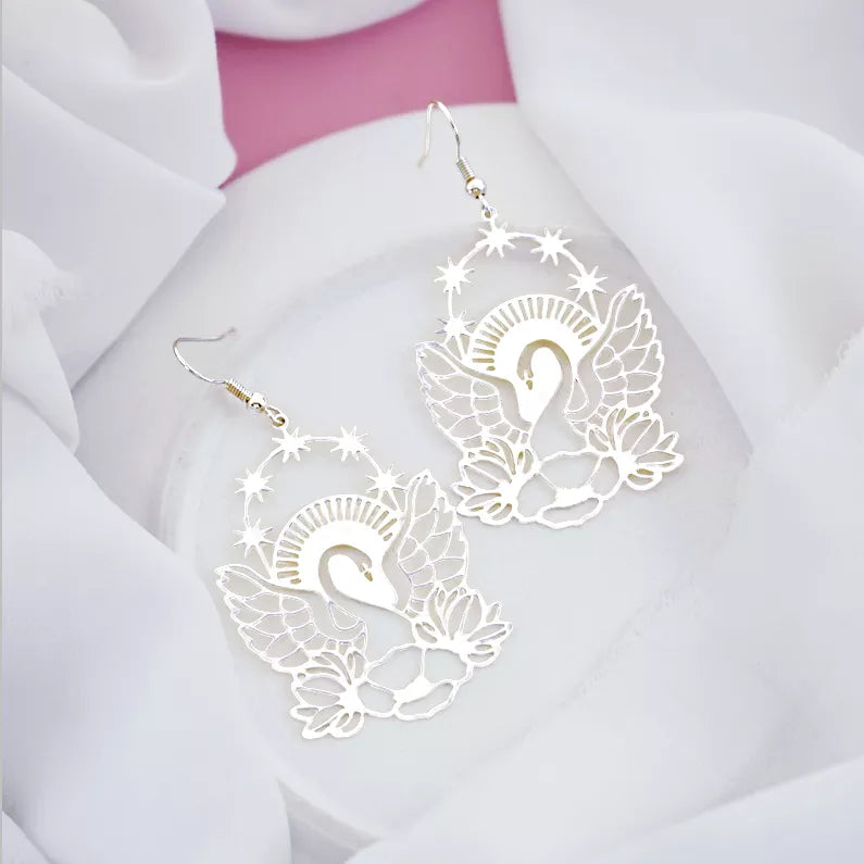 silver dangle earrings with stars, sunlight, wings and lotus flower design
