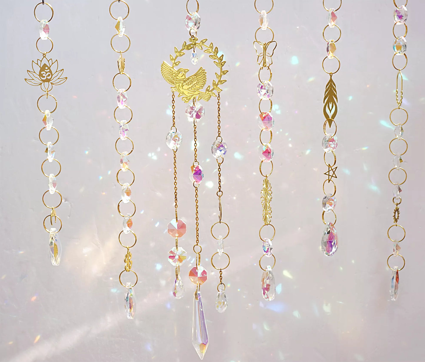 handmade suncatchers featuring delicate brass charms in the shape of birds, butterflies, lotus flowers, and ginkgo leaves