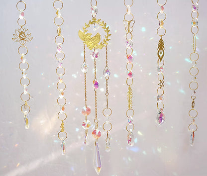 handmade suncatchers featuring delicate brass charms in the shape of birds, butterflies, lotus flowers, and ginkgo leaves